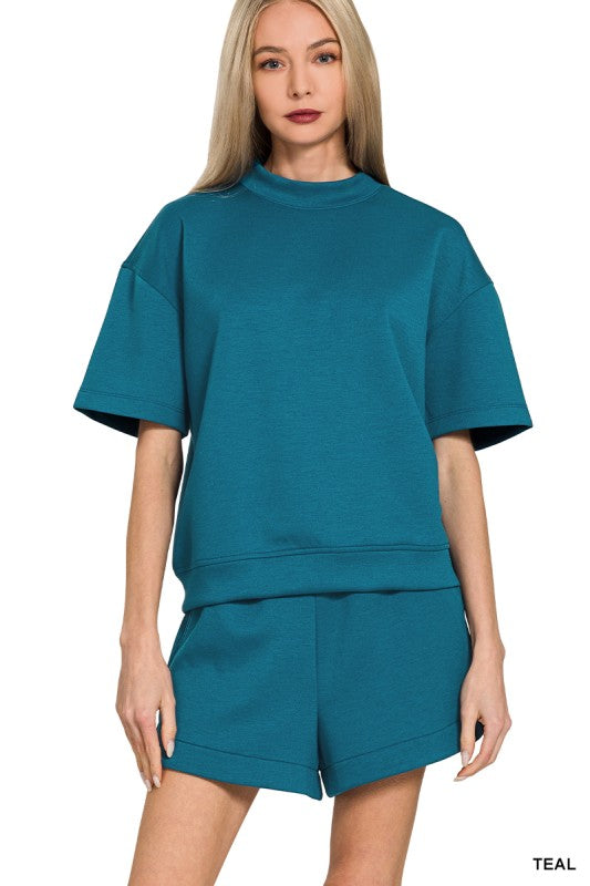 Woman wearing teal shorts set