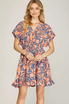 Model wearing orange and blue dress