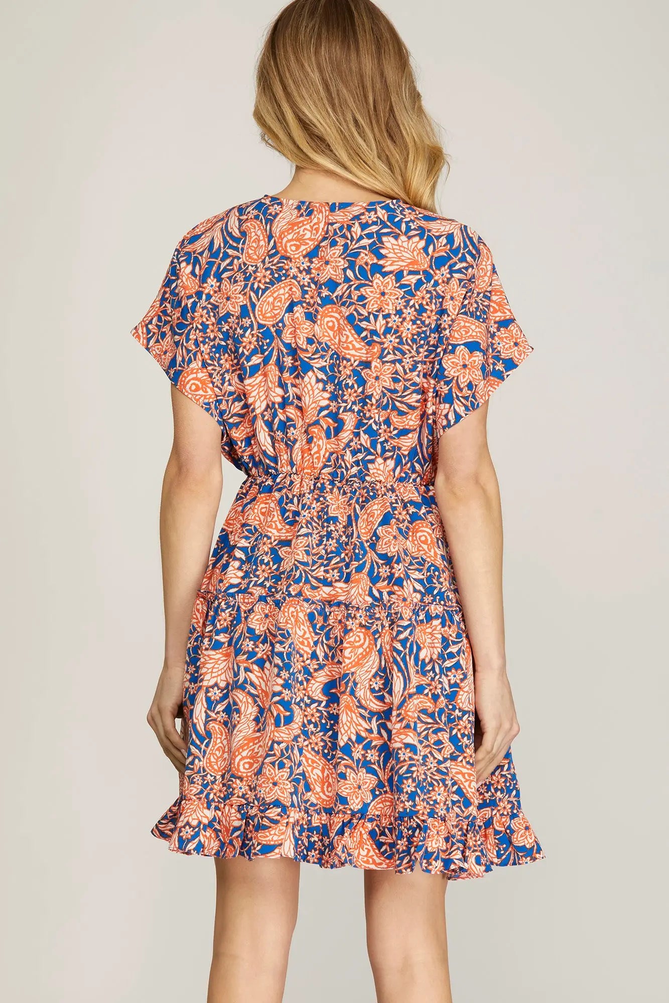 Back view of model, wearing orange and blue dress
