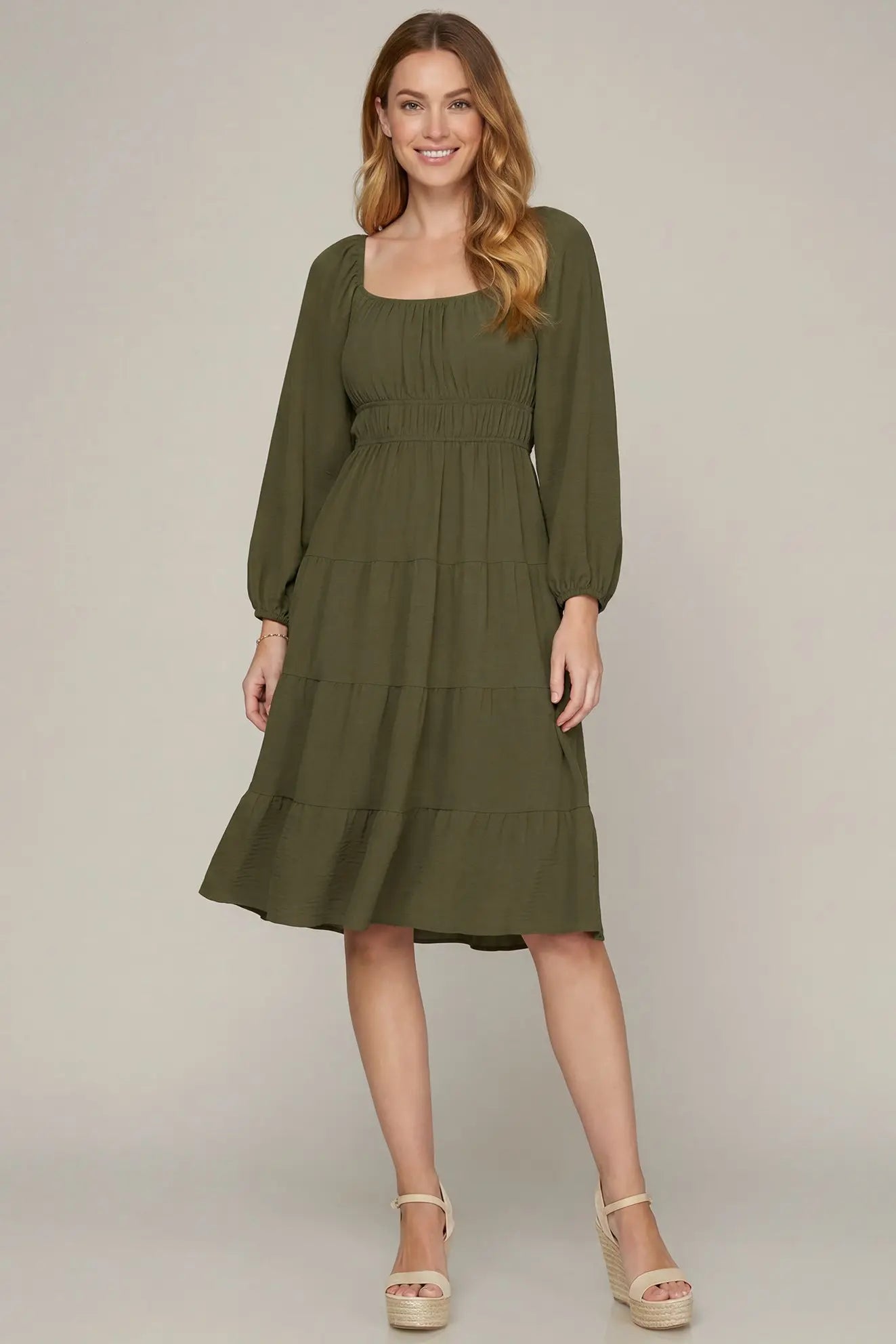 Model wearing olive long sleeve dress