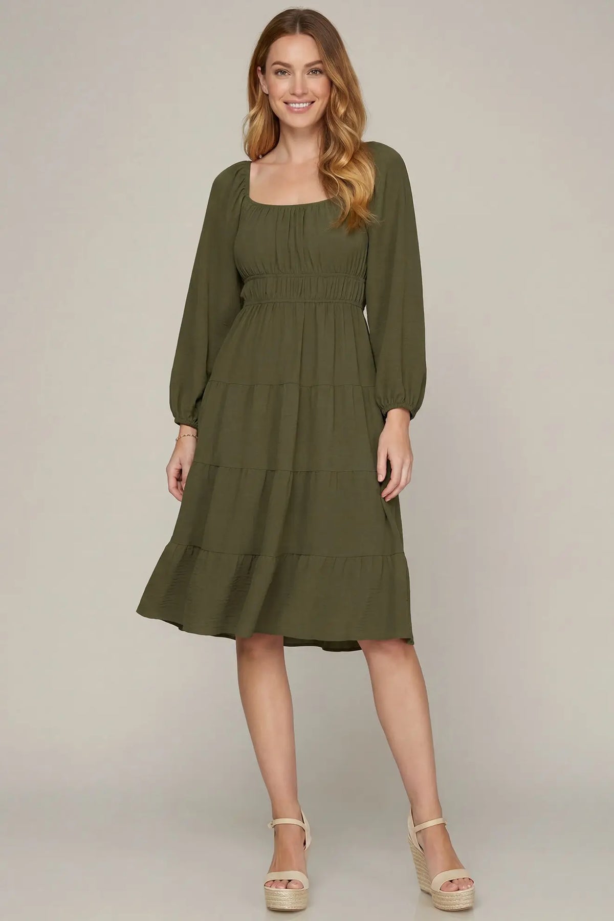 Model wearing olive long sleeve dress