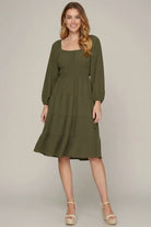 Model wearing olive long sleeve dress