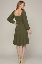 Back of model wearing olive longsleeve dress