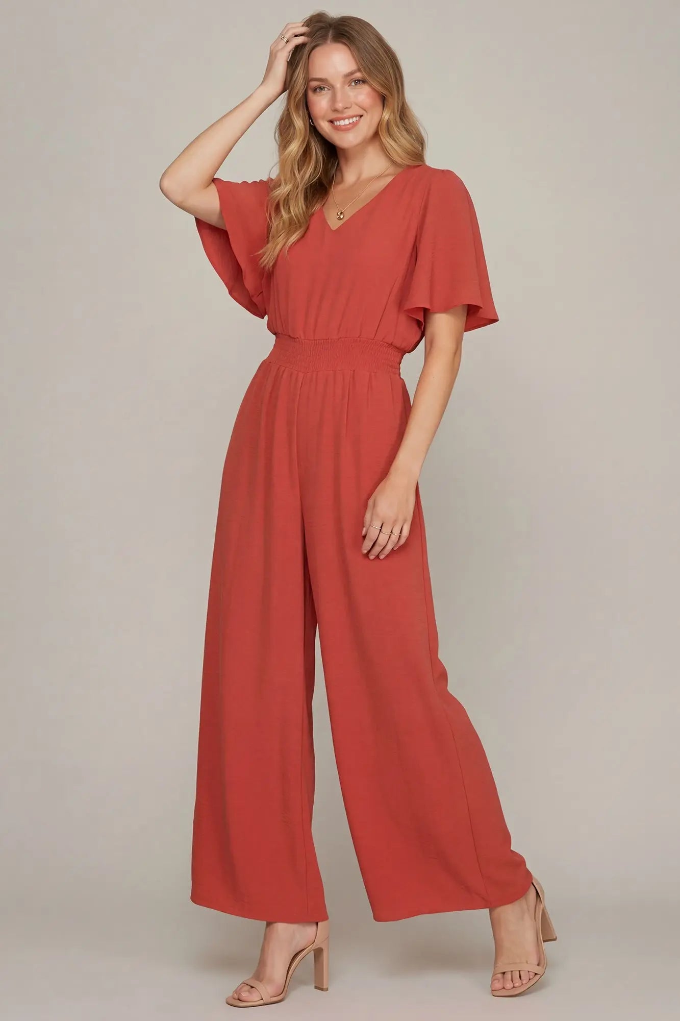 Model wearing coral flounce sleeve   jumpsuit
