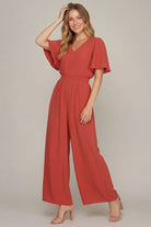 Model wearing coral flounce sleeve   jumpsuit