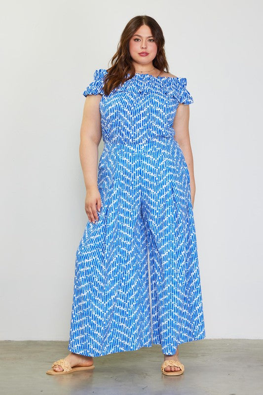 Model wearing blue printed pants and printed shirt to match against a white background