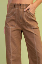 Brown pants worn by a person on a green background
