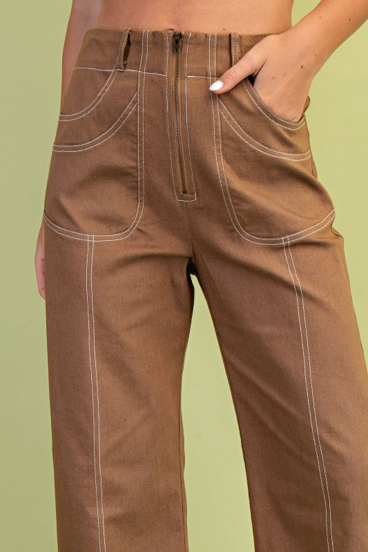 Brown pants worn by a person on a green background