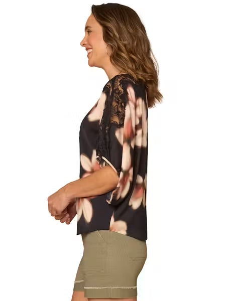 Side view Model wearing dolman top and shorts on a white background. 