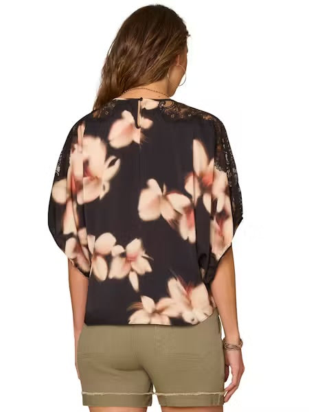 back view Model wearing dolman top and shorts on a white background. 