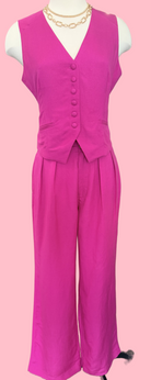 Pink sleeveless top and wide-leg pants on a mannequin against a pink background