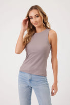 MODEL WEARING STONE TANK AND JEANS