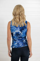 Person wearing a blue floral sleeveless top back view 