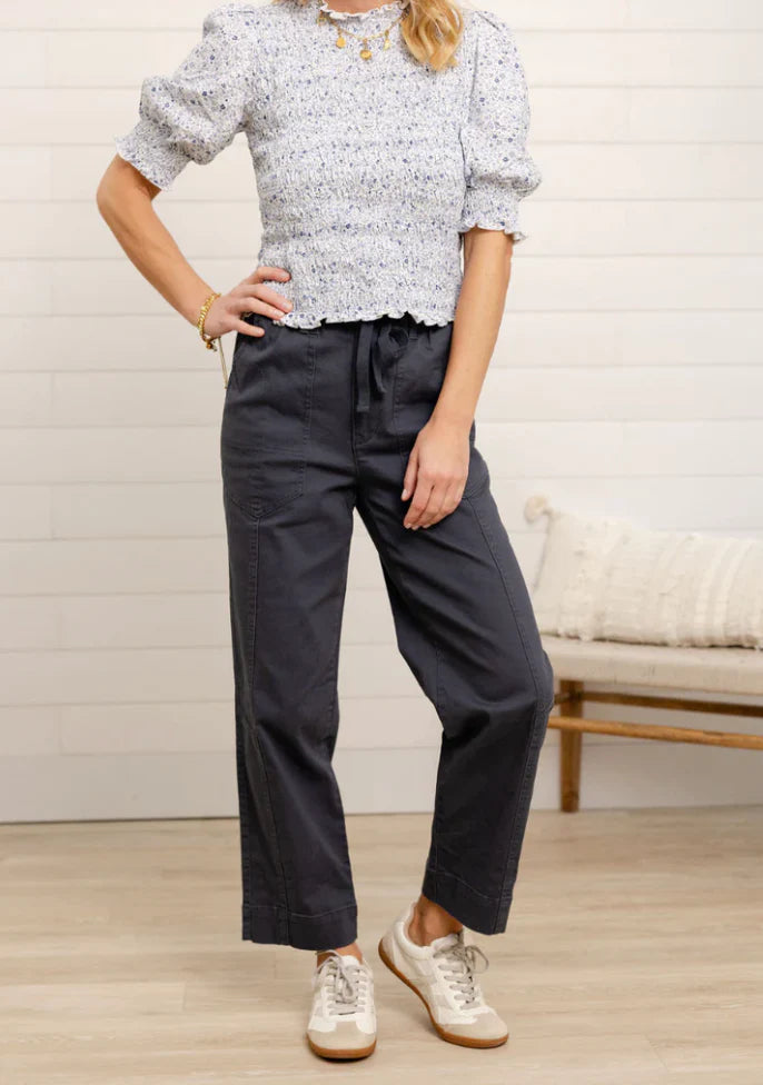 Woman wearing  dark straight leg 
pants