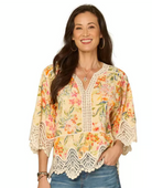 Woman wearing a floral blouse with lace details 