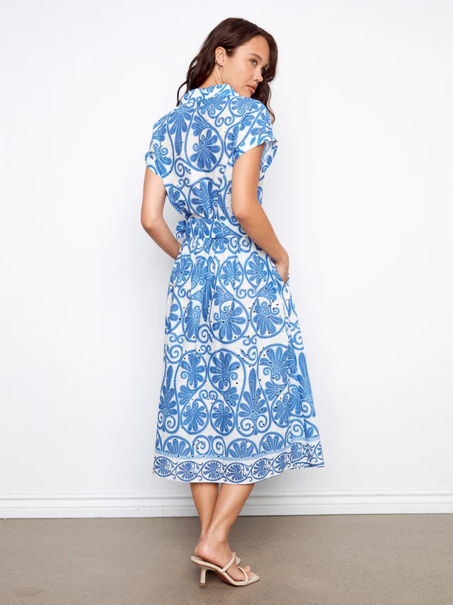 Back of woman wearing a blue and white patterned dress 
