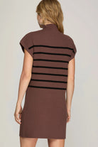 back view ofModel wearing chocolate mock neck dress with black stripes