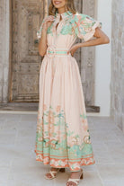 Woman wearing a floral dress with bet 