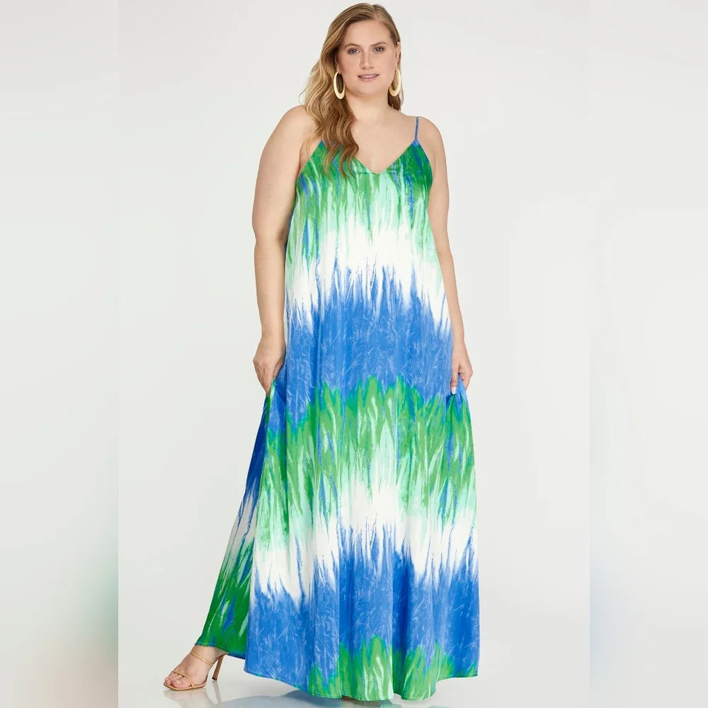 Woman wearing a dress with blue and green patterns 