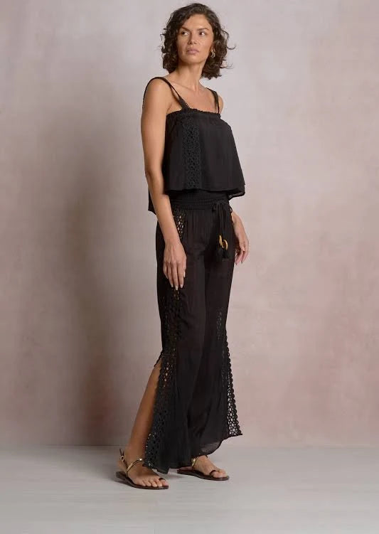 Side profile of woman wearing a black lace top