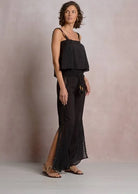 Side profile of woman wearing a black lace top