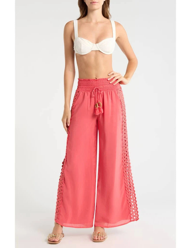 Woman wearing coral pants with lace details 