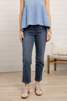 Person wearing high rise slim straight  jeans 