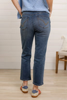Back of person wearing high rise slim straight  jeans 