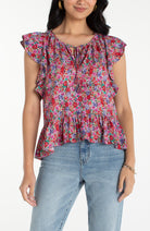 Woman wearing a colorful floral blouse 