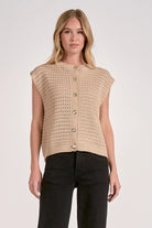 Woman wearing a beige knitted vest 