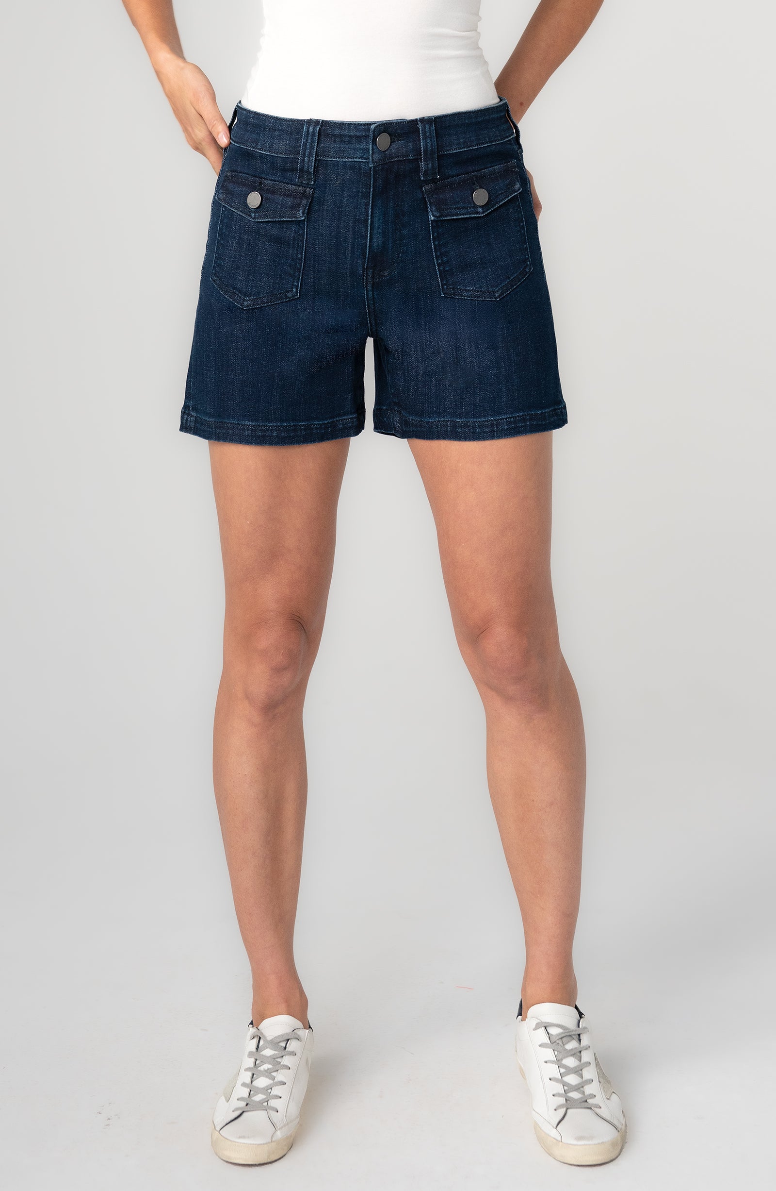 Person wearing dark blue denim shorts 