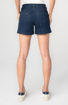 Person wearing dark blue denim shorts
