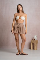 Woman wearing flowy beige shorts 